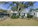 Charming home with a spacious front yard, large tree, and white fence at 186 Sans Souci St, Charleston, SC 29403