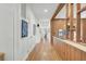 Long hallway with hardwood floors and wood wall accents at 186 Sans Souci St, Charleston, SC 29403