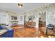 Sunlit living room boasts hardwood floors, floral wallpaper and stylish furnishings at 186 Sans Souci St, Charleston, SC 29403