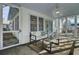 Charming screened porch, perfect for relaxing, features a comfy couch and a coffee table at 186 Sans Souci St, Charleston, SC 29403