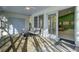 Relaxing screened porch with comfy seating and views of the backyard at 186 Sans Souci St, Charleston, SC 29403