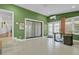 Bright sunroom features hexagonal tile floors, built-in shelving, and sliding glass doors at 186 Sans Souci St, Charleston, SC 29403