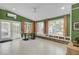 Sunroom with hexagonal tile floor, built-in shelving, and French doors at 186 Sans Souci St, Charleston, SC 29403