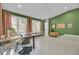 Bright sunroom boasts a large workspace, built-in shelving, and ample natural light at 186 Sans Souci St, Charleston, SC 29403