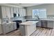 Modern kitchen featuring gray cabinets, quartz countertops, and stainless steel appliances at 191 Blueway Ave, Summerville, SC 29486