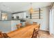 Dining room with a farmhouse table, hardwood floors, and kitchen view at 2005 Isabela Ct, Summerville, SC 29483