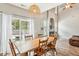 Dining room with a farmhouse table, hardwood floors, and access to the backyard at 2005 Isabela Ct, Summerville, SC 29483