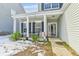 Covered front porch with white columns and a black bench at 2005 Isabela Ct, Summerville, SC 29483