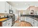 Modern kitchen with white cabinets, stainless steel appliances, and hardwood floors at 2005 Isabela Ct, Summerville, SC 29483