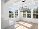 Sunlit dining area with hardwood floors and a stylish light fixture at 3893 James Bay Rd, Johns Island, SC 29455