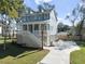 Two-story home with gray siding, white trim, and a detached garage at 3893 James Bay Rd, Johns Island, SC 29455