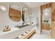 Spa-like bathroom with double vanity, large mirrors, and wood features at 3 Chisolm St # 106, Charleston, SC 29401