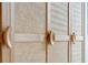 Close-up of a modern cabinet with woven paneling and unique hardware at 3 Chisolm St # 106, Charleston, SC 29401