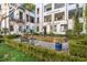 Charming courtyard with lush greenery, a water feature, and seating areas at 3 Chisolm St # 106, Charleston, SC 29401