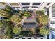 Secluded courtyard with pond, stonework, and palm trees at 3 Chisolm St # 106, Charleston, SC 29401