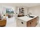 Open concept kitchen with marble island and living room view at 3 Chisolm St # 106, Charleston, SC 29401