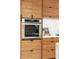 Modern kitchen with stainless steel appliances and wood cabinetry at 3 Chisolm St # 106, Charleston, SC 29401
