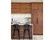 Island kitchen with marble countertops and black barstools at 3 Chisolm St # 106, Charleston, SC 29401