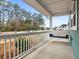 Front porch with a swing, white railings, and view of the street at 312 Parish Farms Dr, Summerville, SC 29486