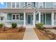 Front porch with white columns, a swing, and landscaping at 312 Parish Farms Dr, Summerville, SC 29486