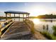 Wooden dock on peaceful lake at sunrise, offering tranquil views at 312 Parish Farms Dr, Summerville, SC 29486