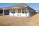 Covered patio and grassy yard with a view of neighboring homes at 333 Dahlia Row Dr, Summerville, SC 29486