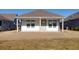 Small backyard patio with white exterior walls and gray roof at 333 Dahlia Row Dr, Summerville, SC 29486
