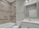 Bathroom with a single vanity, tub, and updated tile at 333 Dahlia Row Dr, Summerville, SC 29486