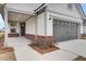 Covered front porch with brick columns and a dark door at 333 Dahlia Row Dr, Summerville, SC 29486