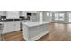 Modern kitchen with white cabinets, quartz countertops, and an island at 333 Dahlia Row Dr, Summerville, SC 29486