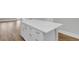 White kitchen island with white cabinets and quartz countertop at 333 Dahlia Row Dr, Summerville, SC 29486