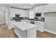 Modern kitchen with white cabinets, stainless steel appliances, and quartz countertops at 333 Dahlia Row Dr, Summerville, SC 29486