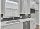 Kitchen sink and counter with white cabinets and dark hexagon backsplash at 333 Dahlia Row Dr, Summerville, SC 29486
