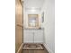 Small bathroom with granite countertop, white cabinets, and barn door at 407 Yacht Harbor Ct, Isle of Palms, SC 29451