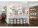 Modern kitchen with white cabinets, granite counters, and bar seating at 407 Yacht Harbor Ct, Isle of Palms, SC 29451