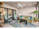Relaxing sunroom with a green couch and a ceiling fan at 407 Yacht Harbor Ct, Isle of Palms, SC 29451