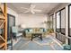 Relaxing sunroom with a green couch and a ceiling fan at 407 Yacht Harbor Ct, Isle of Palms, SC 29451