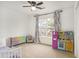 Bright bedroom with window, toy kitchen, and colorful storage at 4822 Cane Pole Ln, Summerville, SC 29485
