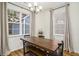 Bright dining room features a rustic wood table, bench seating, and large windows at 4822 Cane Pole Ln, Summerville, SC 29485