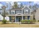 Two-story blue house with front porch and landscaped yard at 4822 Cane Pole Ln, Summerville, SC 29485