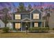 Two-story blue house with front porch, illuminated at dusk at 4822 Cane Pole Ln, Summerville, SC 29485