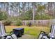 Private backyard with patio, fire pit, and wood fence at 4845 Carnoustie Ct, Summerville, SC 29485