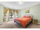 Cozy bedroom with bay window, coral bedding, and a neutral color palette at 4845 Carnoustie Ct, Summerville, SC 29485