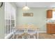 Bright dining area with table and chairs, view to kitchen at 4845 Carnoustie Ct, Summerville, SC 29485