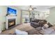 Spacious living room with fireplace, large windows, and plush sofas at 4845 Carnoustie Ct, Summerville, SC 29485