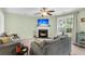 Living room with corner fireplace, large TV, and ample seating at 4845 Carnoustie Ct, Summerville, SC 29485