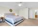 Main bedroom with king bed, ceiling fan, and en-suite bathroom at 4845 Carnoustie Ct, Summerville, SC 29485