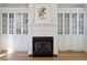 Living room with hardwood floors, fireplace, and built-in shelving at 5 Wraggborough Ln, Charleston, SC 29403