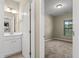 Bright bathroom with white vanity and access to bedroom at 5440 Overland Trl, North Charleston, SC 29420