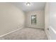 Simple carpeted bedroom with window and neutral walls at 5440 Overland Trl, North Charleston, SC 29420